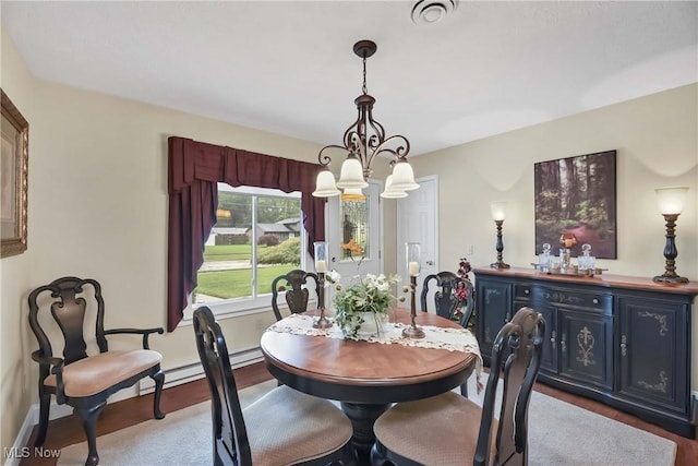 1421 Rolling Meadows Dr, Vermilion, OH 44089 - dining room with a chandelier, wood finished floors, and baseboards
