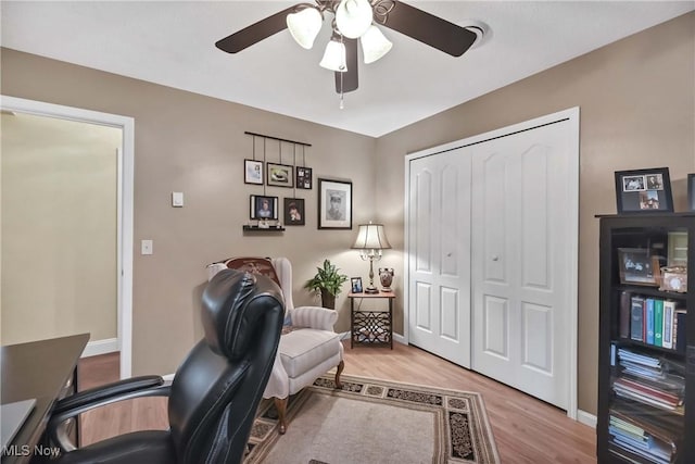1421 Rolling Meadows Dr, Vermilion, OH 44089 - home office featuring light wood-type flooring, ceiling fan, and baseboards