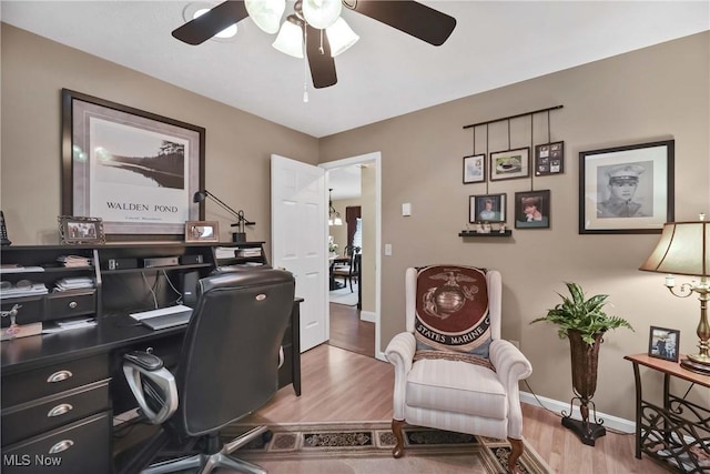 1421 Rolling Meadows Dr, Vermilion, OH 44089 - office featuring a ceiling fan, wood finished floors, and baseboards