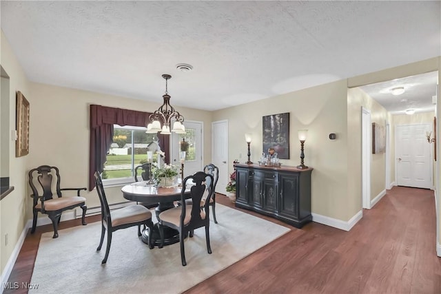 1421 Rolling Meadows Dr, Vermilion, OH 44089 - dining space featuring wood finished floors, a chandelier, baseboards, and a textured ceiling