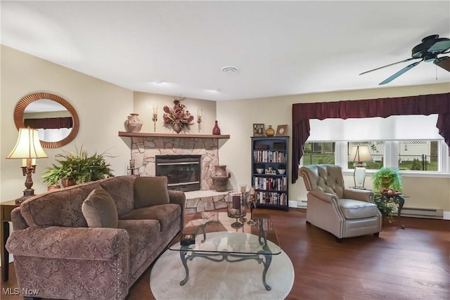 1421 Rolling Meadows Dr, Vermilion, OH 44089 - living area with wood finished floors, a baseboard heating unit, a fireplace, and ceiling fan