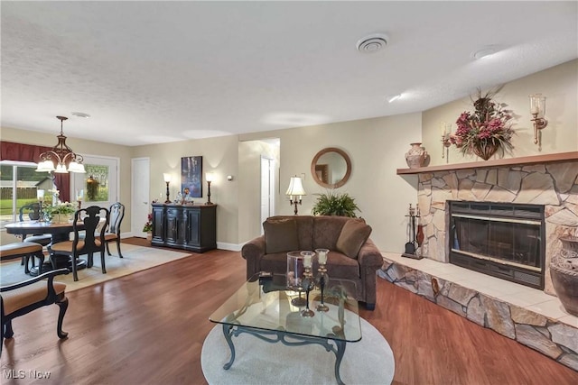 1421 Rolling Meadows Dr, Vermilion, OH 44089 - living area with wood finished floors, a fireplace, a chandelier, and baseboards