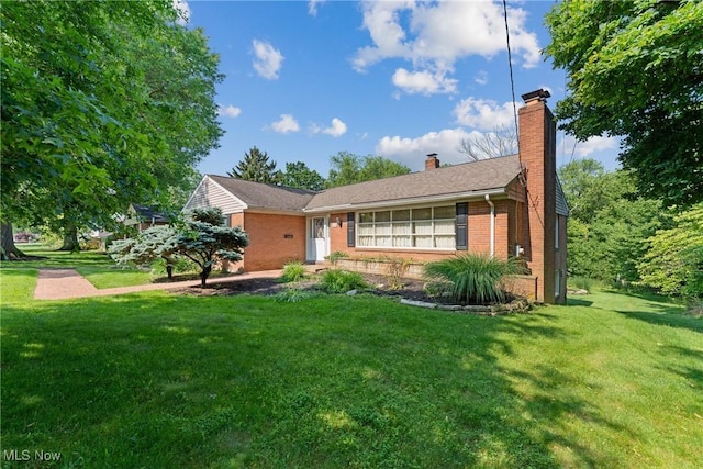 923 Hillcrest Ave SW, North Canton, OH 44720 - ranch-style home with brick siding, a chimney, and a front yard