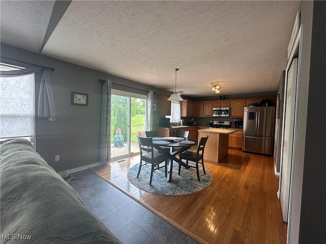 2280 Becket Cir, Stow, OH 44224 - dining area with a textured ceiling, light wood-style flooring, and baseboards