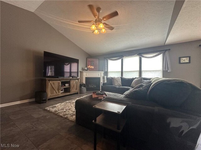 2280 Becket Cir, Stow, OH 44224 - living room featuring lofted ceiling, a textured ceiling, a ceiling fan, a fireplace, and baseboards