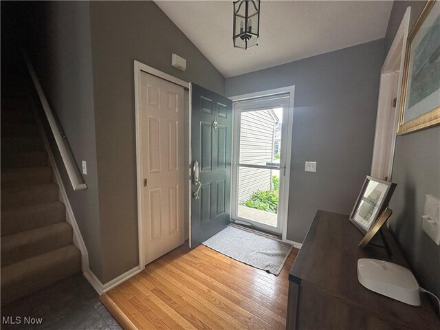 2280 Becket Cir, Stow, OH 44224 - entryway featuring lofted ceiling, light wood finished floors, baseboards, and stairs