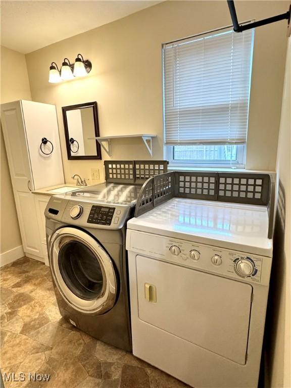 354 Hamilton Ave, Coshocton, OH 43812 - laundry area with independent washer and dryer, stone finish flooring, and cabinet space