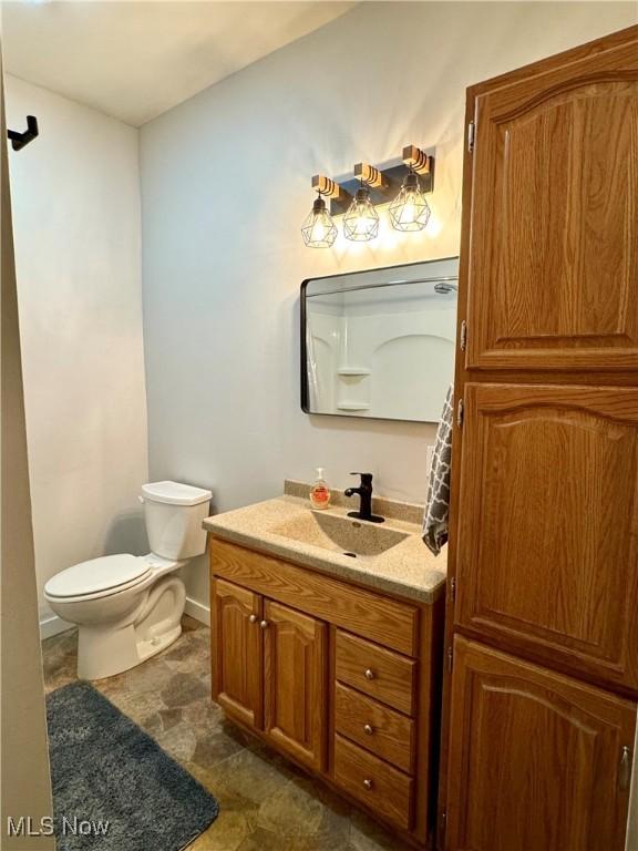 354 Hamilton Ave, Coshocton, OH 43812 - half bathroom featuring vanity, toilet, and baseboards