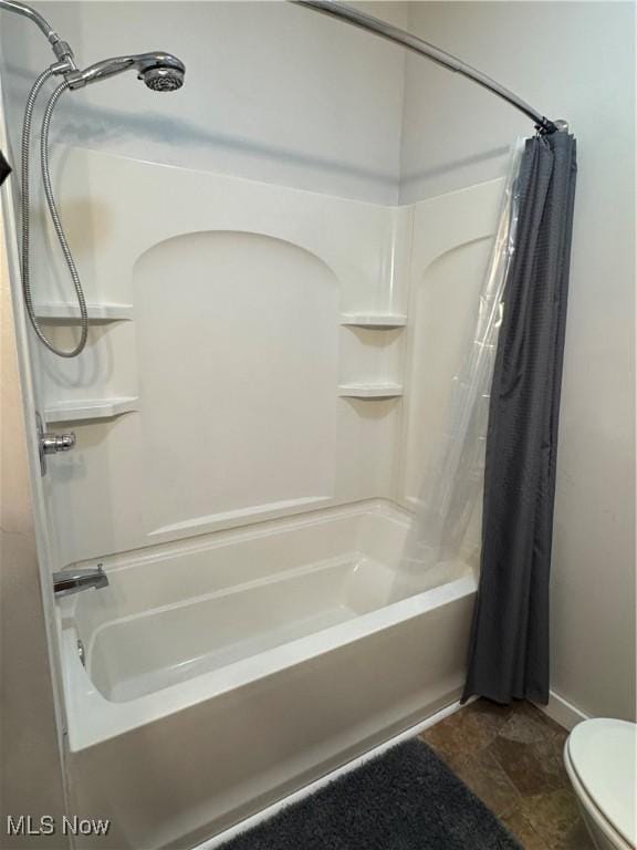 354 Hamilton Ave, Coshocton, OH 43812 - full bathroom featuring shower / bath combo, toilet, and stone finish floors