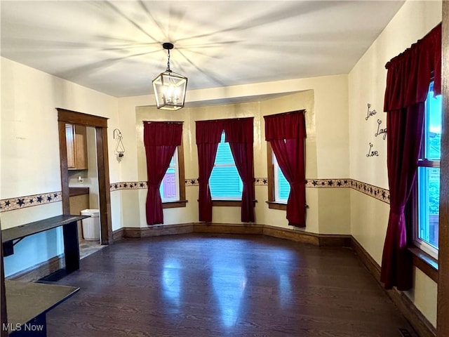 354 Hamilton Ave, Coshocton, OH 43812 - unfurnished dining area featuring healthy amount of natural light, a chandelier, and wood finished floors