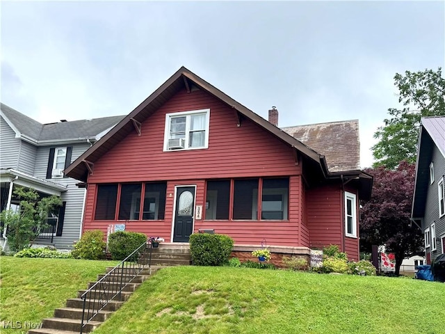354 Hamilton Ave, Coshocton, OH 43812 - view of front facade featuring a chimney and a front lawn