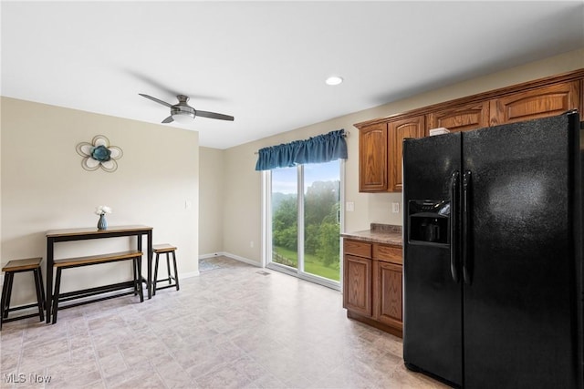60922 Webb Heights Rd, Shadyside, OH 43947 - kitchen with black fridge, brown cabinets, ceiling fan, baseboards, and recessed lighting