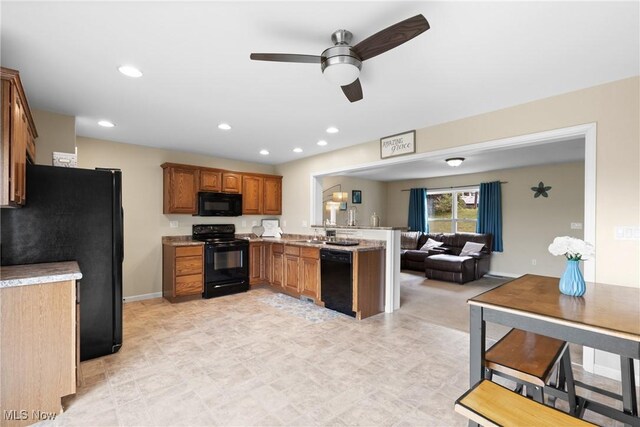 60922 Webb Heights Rd, Shadyside, OH 43947 - kitchen featuring black appliances, a peninsula, open floor plan, brown cabinets, and a ceiling fan