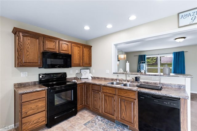 60922 Webb Heights Rd, Shadyside, OH 43947 - kitchen featuring black appliances, a sink, recessed lighting, a peninsula, and brown cabinetry
