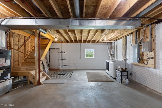 60922 Webb Heights Rd, Shadyside, OH 43947 - basement with washing machine and clothes dryer, electric panel, and brick wall