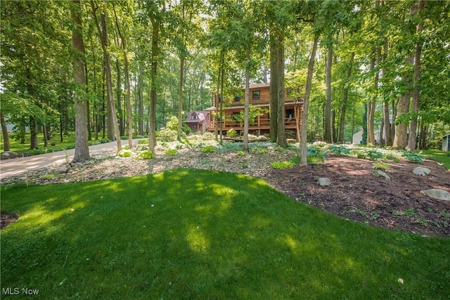 5820 Kildare Cir NW, Canton, OH 44718 - view of green lawn with a wooden deck and a wooded view