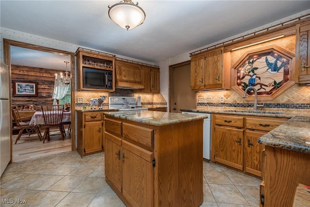5820 Kildare Cir NW, Canton, OH 44718 - kitchen featuring a sink, black microwave, stove, a kitchen island, and light tile patterned flooring
