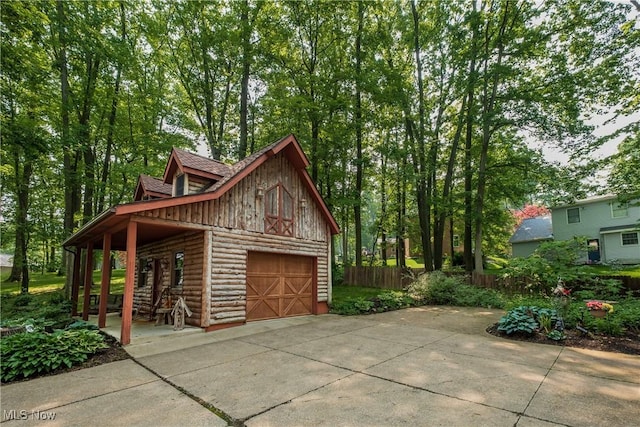5820 Kildare Cir NW, Canton, OH 44718 - garage featuring a detached garage, driveway, and a porch