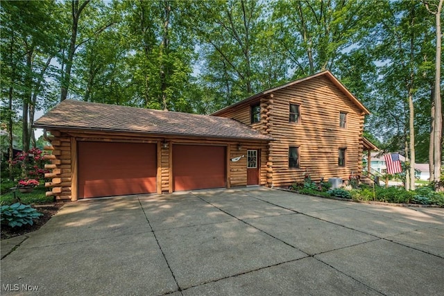 5820 Kildare Cir NW, Canton, OH 44718 - view of front of property featuring log exterior, driveway, a garage, and central AC unit