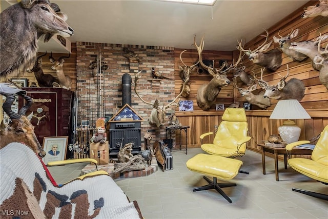 5820 Kildare Cir NW, Canton, OH 44718 - living area featuring a wood stove, wooden walls, and tile patterned flooring