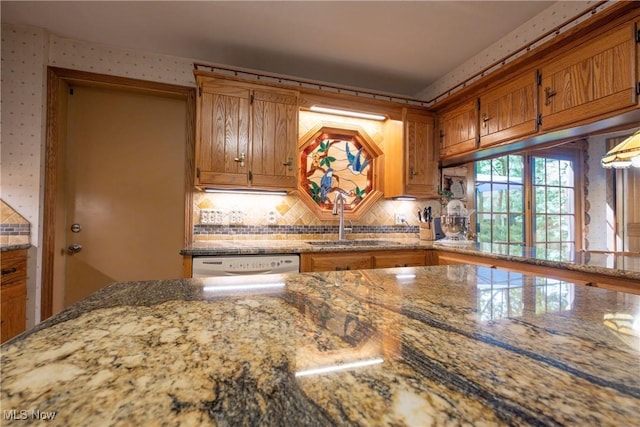 5820 Kildare Cir NW, Canton, OH 44718 - kitchen with a sink, brown cabinets, tasteful backsplash, stone countertops, and wallpapered walls