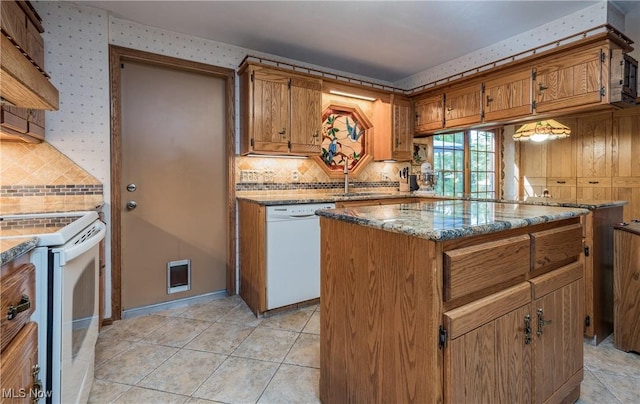 5820 Kildare Cir NW, Canton, OH 44718 - kitchen featuring white appliances, tasteful backsplash, a sink, light stone countertops, and brown cabinets