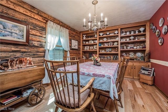 5820 Kildare Cir NW, Canton, OH 44718 - dining area with a chandelier, light wood-type flooring, baseboards, and rustic walls