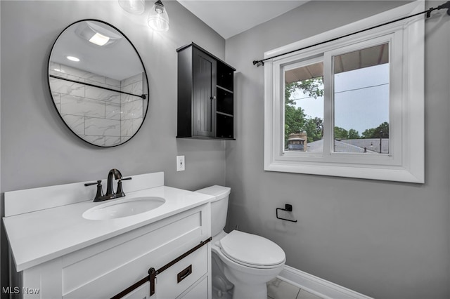 713 Highland Ave, Wadsworth, OH 44281 - full bathroom featuring vanity, toilet, a shower, and baseboards