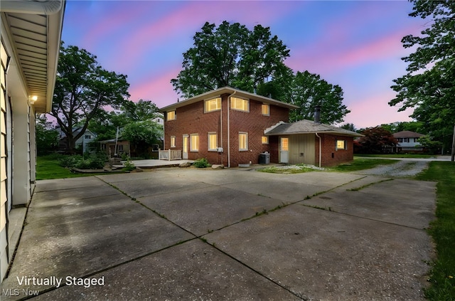 713 Highland Ave, Wadsworth, OH 44281 - view of front of house featuring brick siding, concrete driveway, and a patio