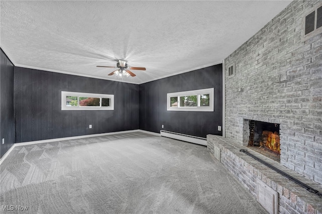 713 Highland Ave, Wadsworth, OH 44281 - unfurnished living room featuring baseboard heating, a ceiling fan, carpet floors, a fireplace, and a textured ceiling