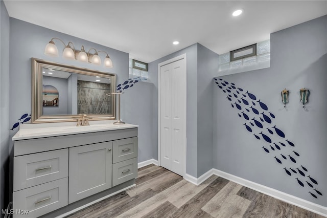 713 Highland Ave, Wadsworth, OH 44281 - full bathroom featuring wood finished floors, vanity, baseboards, a shower, and recessed lighting