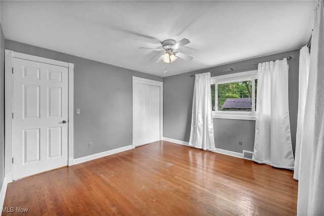713 Highland Ave, Wadsworth, OH 44281 - unfurnished bedroom featuring baseboards, wood finished floors, a closet, and ceiling fan