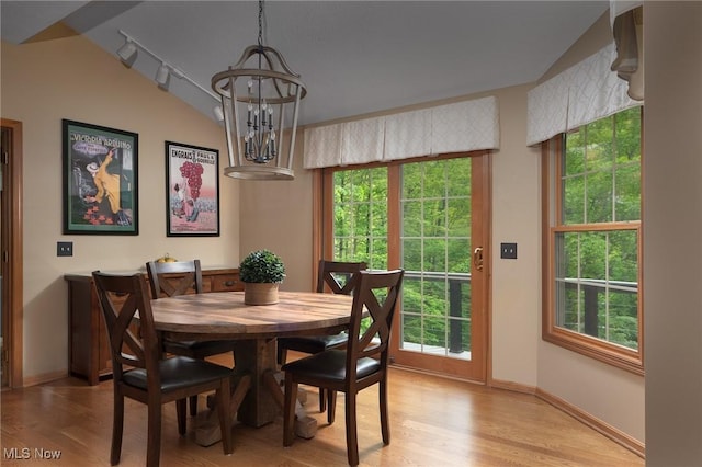 4151 Williamsburg Ct, Medina, OH 44256 - dining space featuring light wood-style flooring, a chandelier, baseboards, and vaulted ceiling
