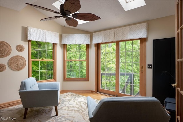 4151 Williamsburg Ct, Medina, OH 44256 - sitting room featuring a skylight, healthy amount of natural light, lofted ceiling, ceiling fan, and baseboards