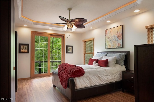 4151 Williamsburg Ct, Medina, OH 44256 - bedroom featuring a raised ceiling, access to exterior, recessed lighting, wood finished floors, and baseboards