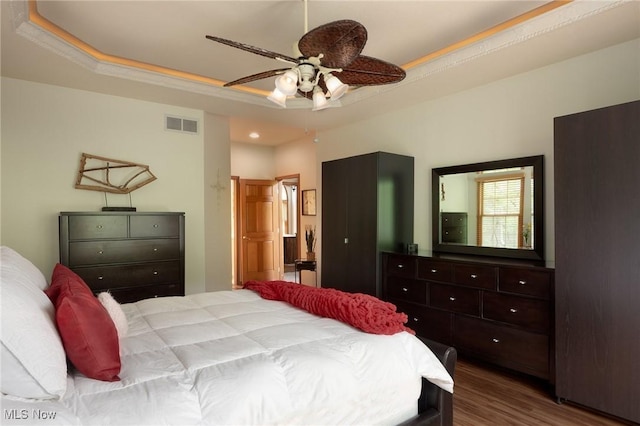 4151 Williamsburg Ct, Medina, OH 44256 - bedroom with wood finished floors, recessed lighting, a ceiling fan, a tray ceiling, and ensuite bathroom