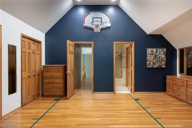 4151 Williamsburg Ct, Medina, OH 44256 - unfurnished bedroom with vaulted ceiling, light wood-style flooring, a closet, ensuite bathroom, and baseboards