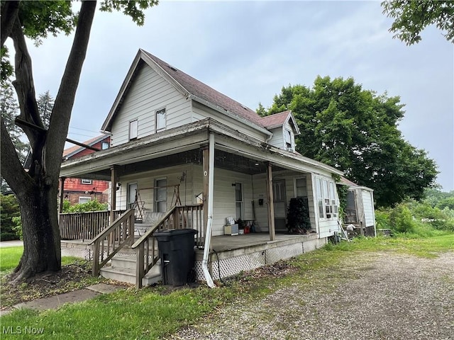 1723 W Prospect Rd, Ashtabula, OH 44004 - view of front facade featuring covered porch and a shingled roof