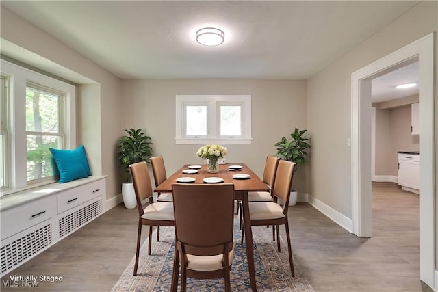 1260 Beardsley St, Akron, OH 44301 - dining room with healthy amount of natural light, wood finished floors, and baseboards
