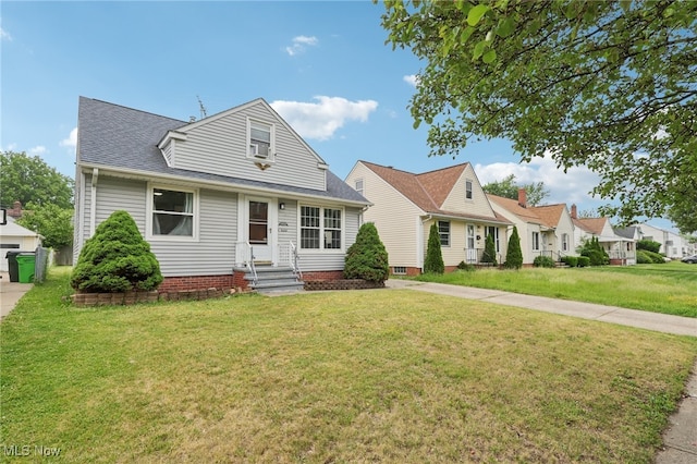 20800 Wilmore Ave, Euclid, OH 44123 - view of front facade with entry steps, a front lawn, and roof with shingles