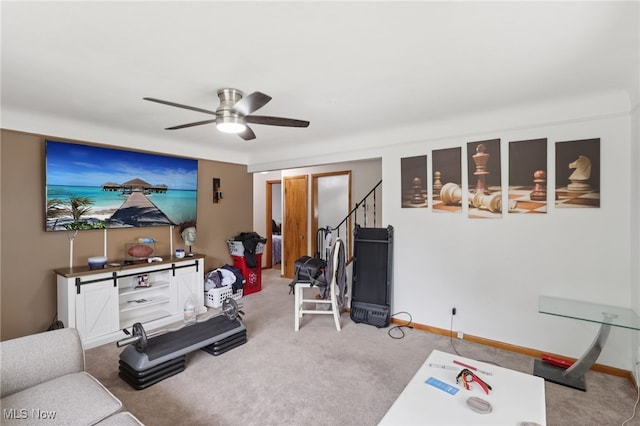 20800 Wilmore Ave, Euclid, OH 44123 - living room with carpet floors, ceiling fan, baseboards, and stairway