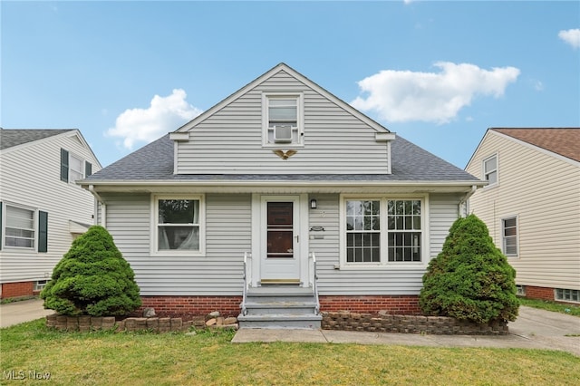 20800 Wilmore Ave, Euclid, OH 44123 - bungalow-style house with entry steps, roof with shingles, a front lawn, and cooling unit