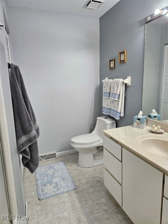 110 Olson Spur, Munroe Falls, OH 44262 - bathroom featuring vanity, toilet, and baseboards