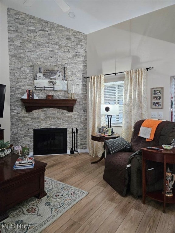 110 Olson Spur, Munroe Falls, OH 44262 - living room featuring wood finished floors, a fireplace, and high vaulted ceiling