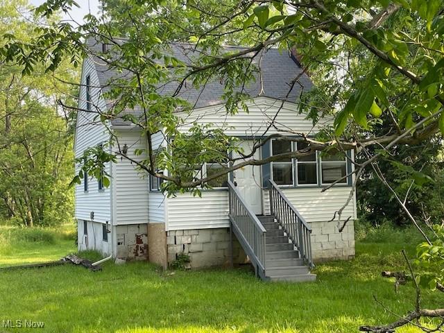 15262 Wadsworth Rittman Rd, Rittman, OH 44270 - rear view of house with a lawn