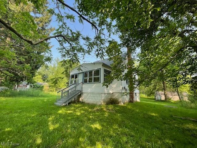 15262 Wadsworth Rittman Rd, Rittman, OH 44270 - view of side of property with a yard