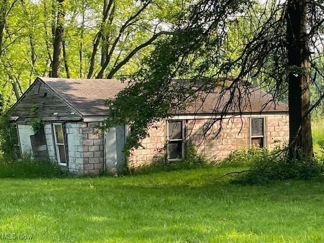15262 Wadsworth Rittman Rd, Rittman, OH 44270 - view of side of property with a yard and a shingled roof