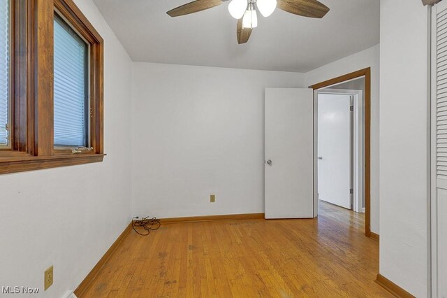 1825 E Skyline Dr, Lorain, OH 44053 - unfurnished room with a ceiling fan, light wood-style floors, and baseboards