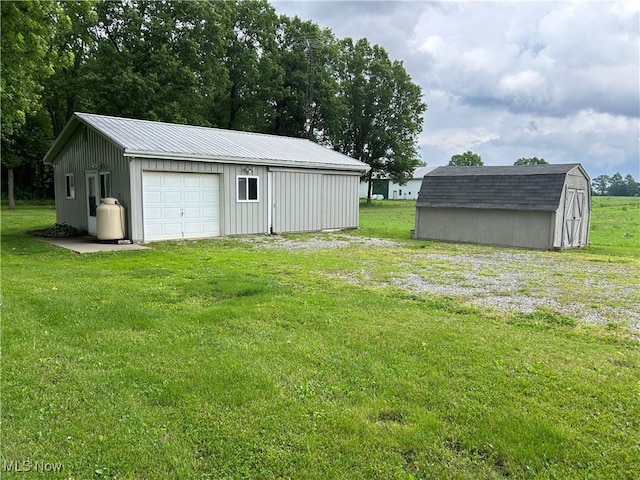 8973 Matty Rd, West Salem, OH 44287 - view of grassy yard with an outdoor structure and a garage