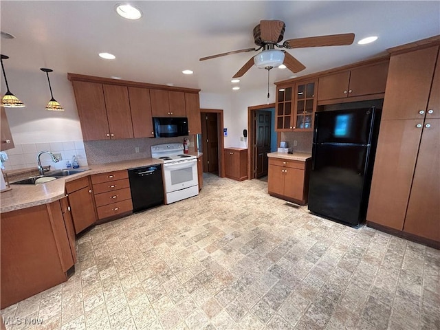 8973 Matty Rd, West Salem, OH 44287 - kitchen with black appliances, a sink, a ceiling fan, light countertops, and brown cabinets